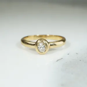 Oval Diamond Bezel Set in Buttery Gold Solitaire Ring